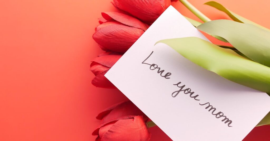 Red tulips and a 'Love you mom' card perfect for Mother's Day greetings.