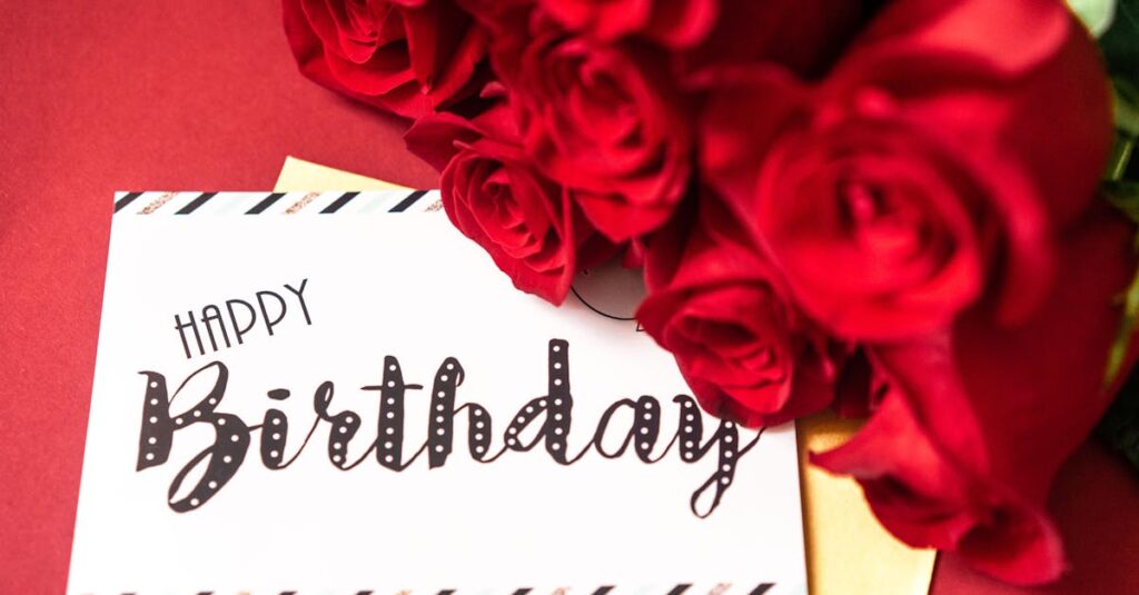 A stylish birthday card surrounded by vibrant red roses on a red background.