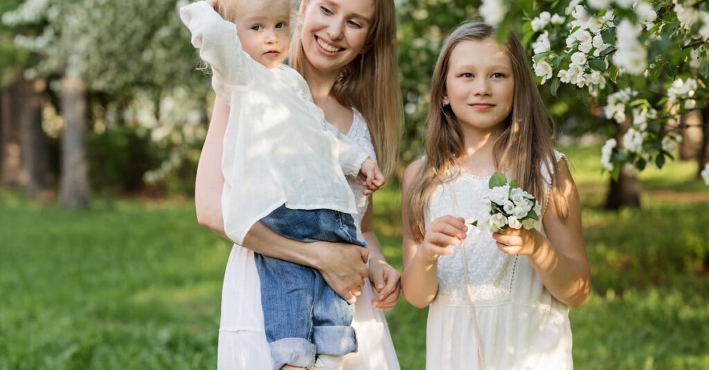 A joyful family moment with mother and children in a blooming park.