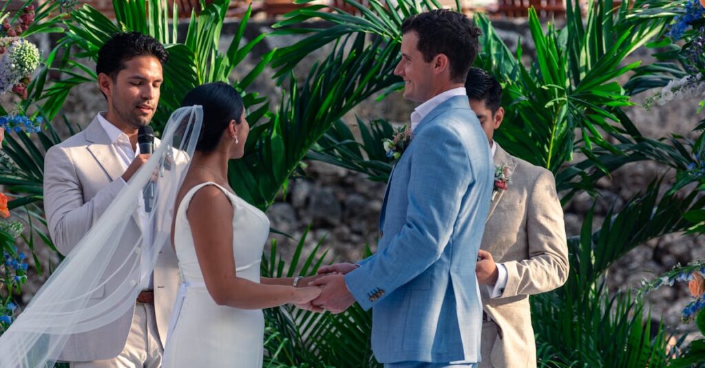 Bride and groom exchanging vows outdoors in a lush, tropical setting.