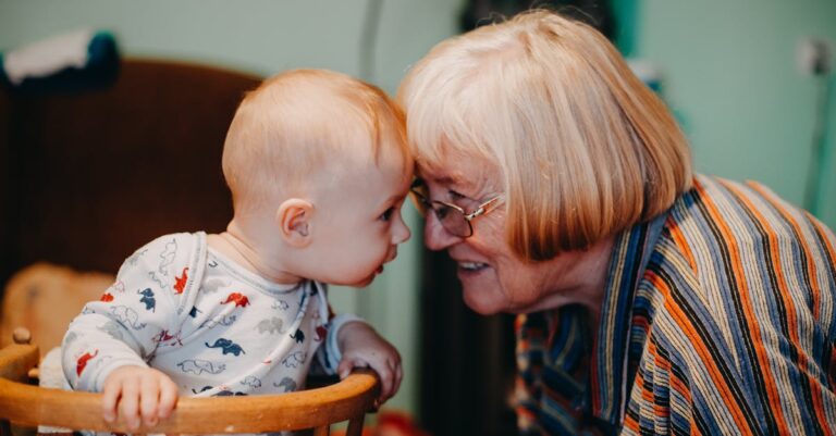 A touching moment shared between a baby and grandmother indoors.