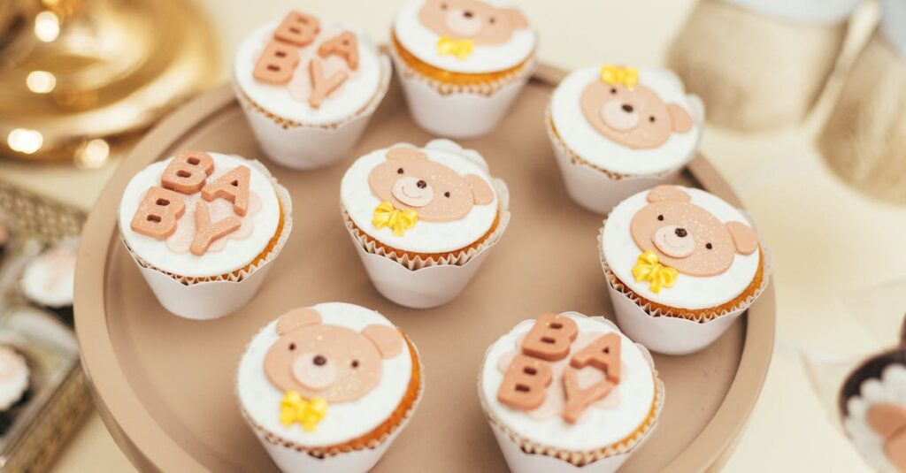 Cute baby shower cupcakes featuring bear decorations and BABY lettering on a stylish tray.