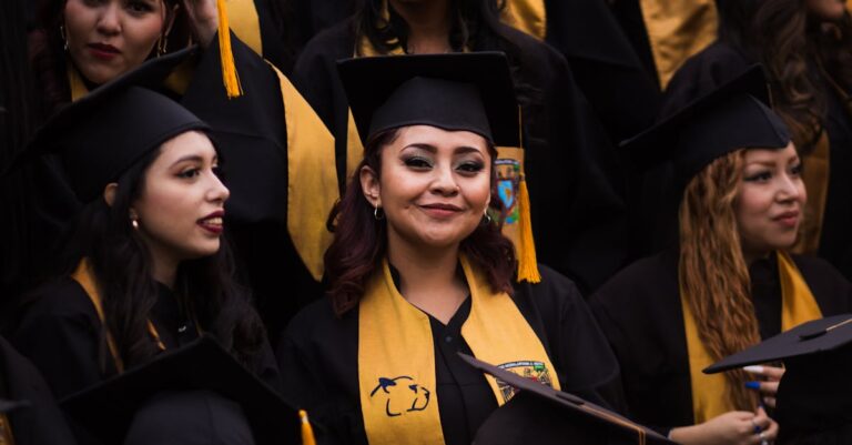 Smiling graduates in caps and gowns celebrate their accomplishments at a graduation ceremony.