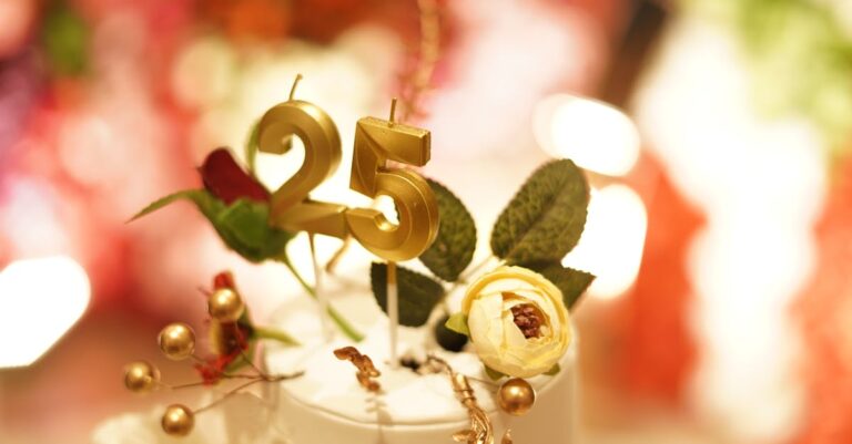 Close-up of a 25th wedding anniversary cake topper with golden decoration and flowers.
