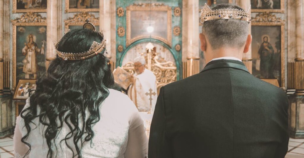 A couple stands before a priest in an ornate Orthodox church during a wedding ceremony.