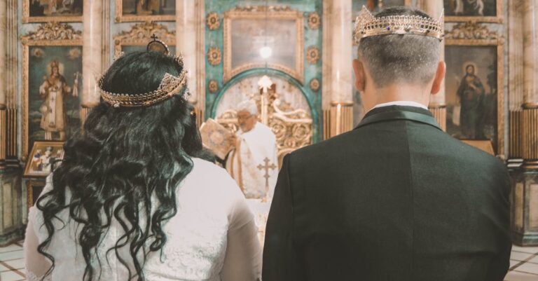A couple stands before a priest in an ornate Orthodox church during a wedding ceremony.
