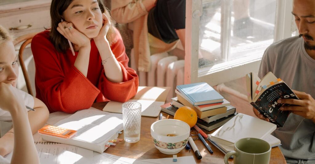 A group of students studying together in a cozy room with books and notes.