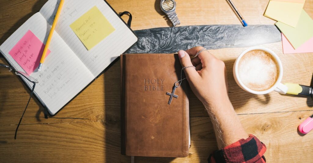 Top view of Bible study setup with coffee, notes, and wooden table.