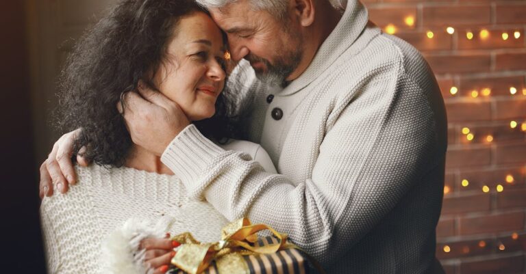 A loving couple exchanges a wrapped gift, symbolizing warmth and affection.