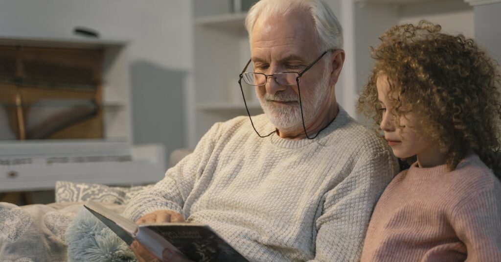 Elderly man and girl reading a book together at home, sharing a cherished moment.