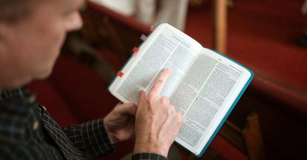pexels-photo-5875275-5875275 An individual reads a Bible in a church pew, focusing on Ephesians.
