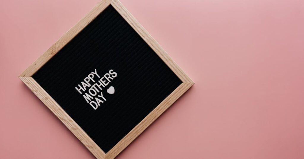 A black letter board with 'Happy Mother's Day' on a pink background, perfect for celebrations.