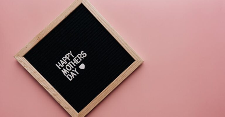 A black letter board with 'Happy Mother's Day' on a pink background, perfect for celebrations.