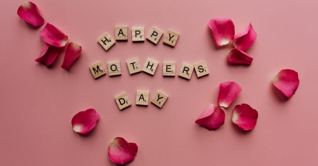 Scrabble tiles spelling 'Happy Mother's Day' surrounded by pink petals.