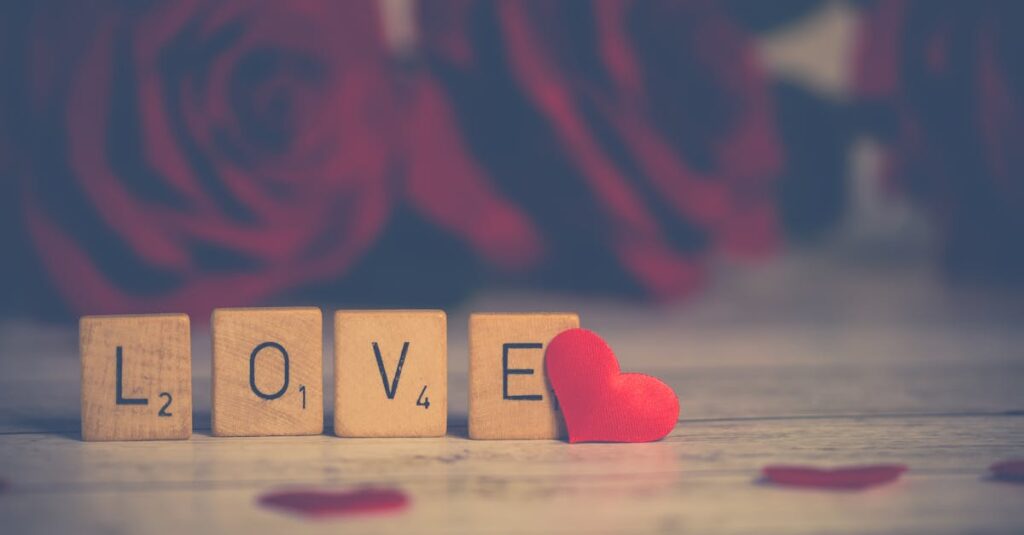 Scrabble tiles spelling 'LOVE' with red roses, perfect for Valentine's Day.