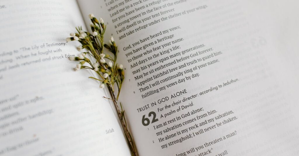 A close-up of an open Bible page with scripture and delicate white flowers.