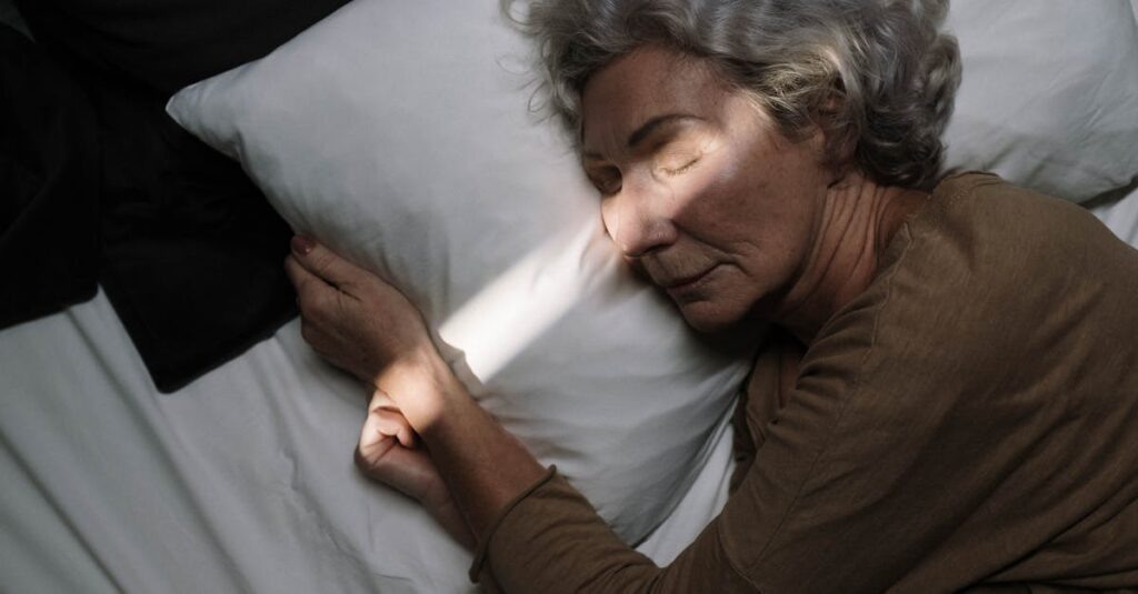 A serene moment of an elderly woman peacefully sleeping on a bed with soft lighting.