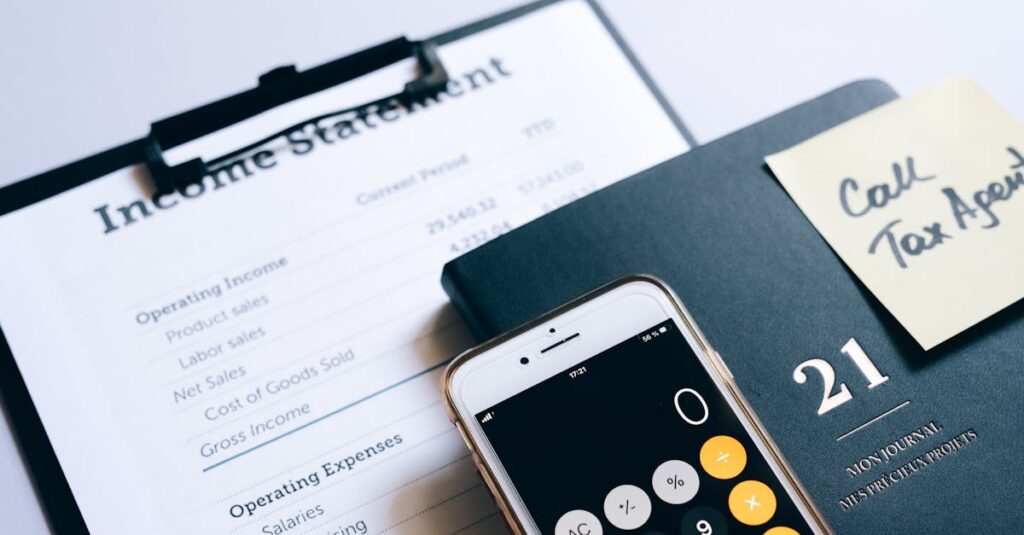 Close-up of income statement, calculator, and planner for financial planning.
