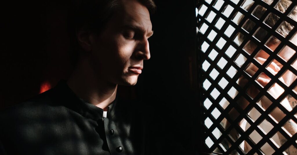 A priest listens to a penitent in a dimly lit confessional, embodying themes of faith and repentance.