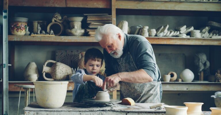 Elderly man teaching young boy pottery in a rustic workshop, emphasizing bonding and skills.