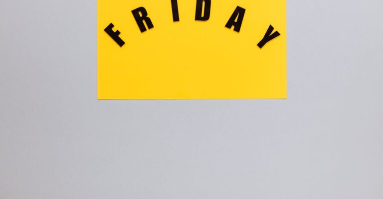 Bold black letters spelling 'Friday' on a yellow paper with ample copy space.