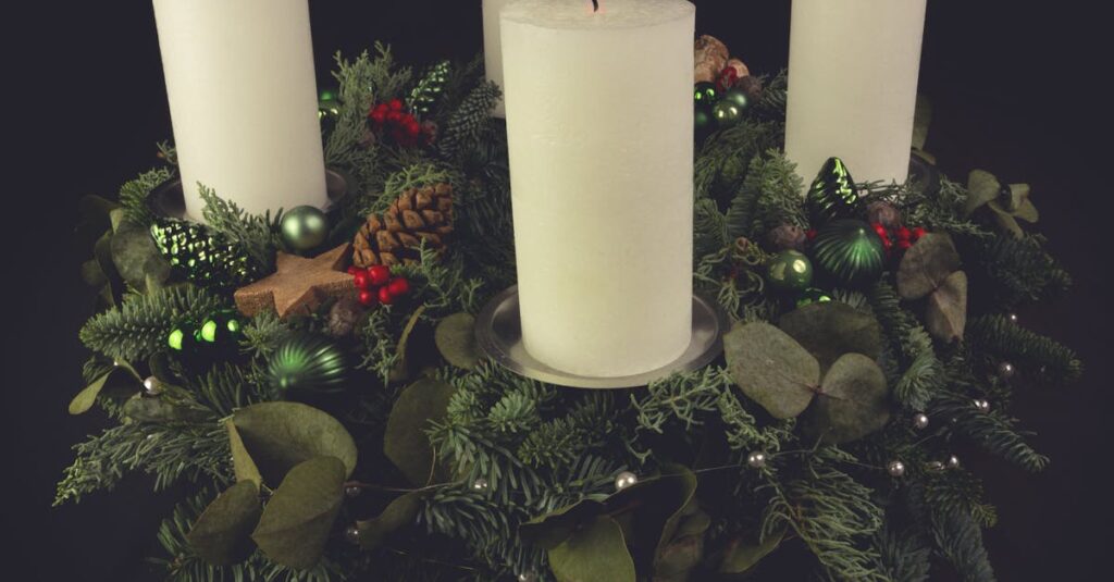 Christmas advent wreath with green foliage, decorated with candles, pinecones, and ornaments.