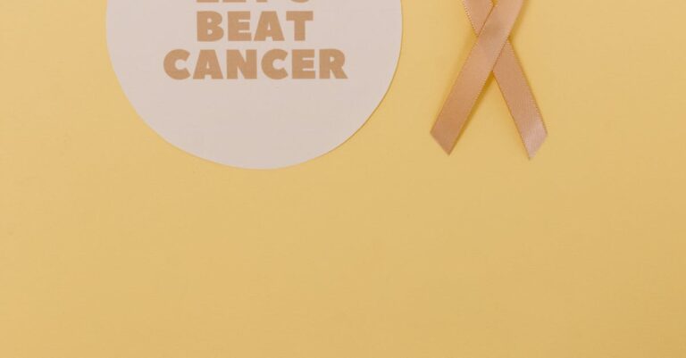 Yellow ribbon symbolizing cancer awareness on a simple background.