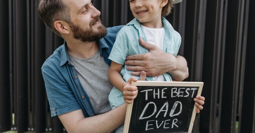 A father and son smiling outdoors holding a 'Best Dad Ever' sign.