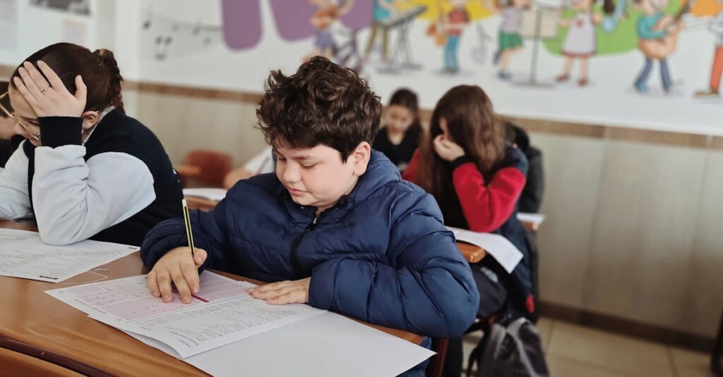 A group of children taking a test with focus and concentration in a classroom setting.