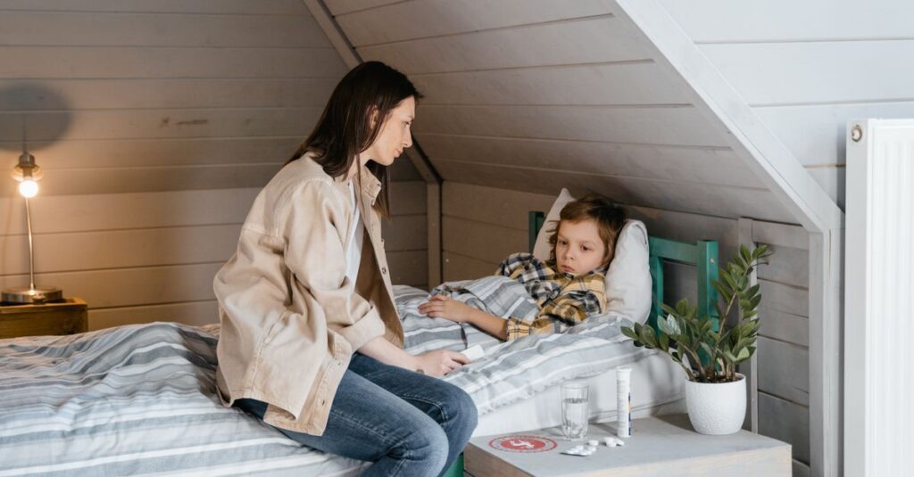 Mother gently caring for her sick child in a cozy bedroom setting, showing love and concern.