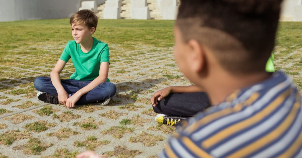 pexels-photo-8033806-8033806 Group of children sitting in a park with bright sunlight, creating a peaceful atmosphere.
