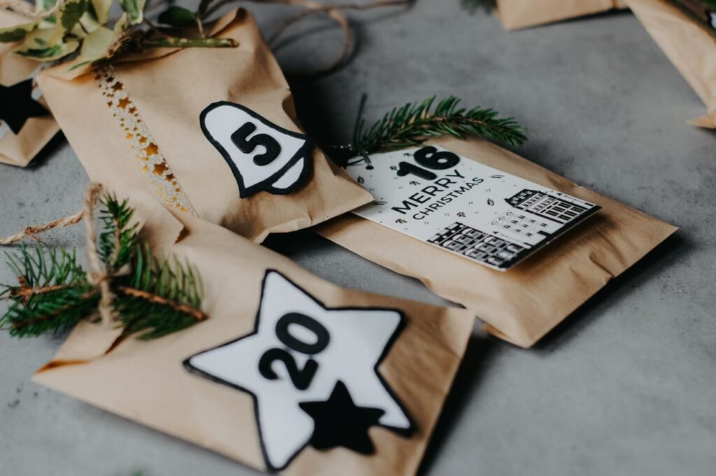 pexels-photo-19312025-19312025 Close-up of Christmas advent calendar with numbered rustic gifts and fir branches on gray background.