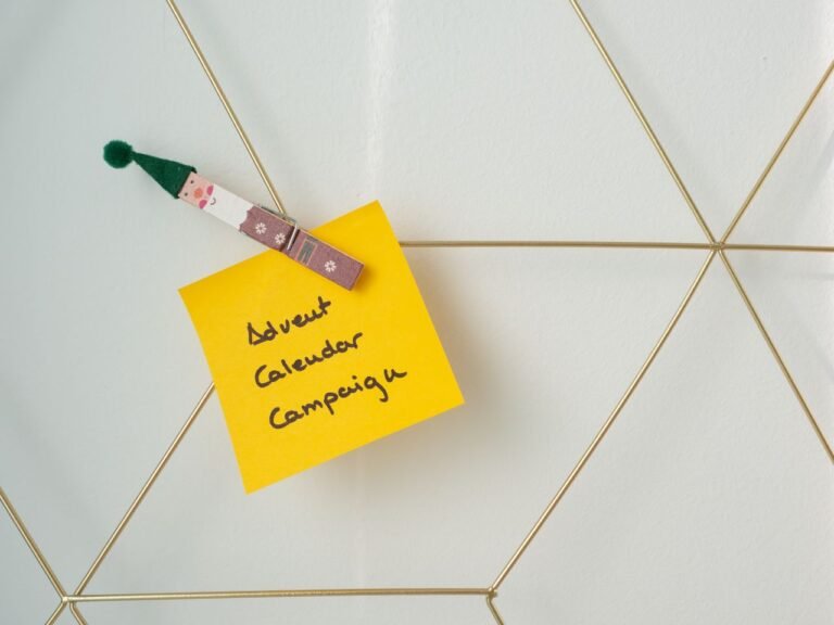 Yellow note with 'Advent Calendar Campaign' clipped to a geometric wire grid, evoking holiday planning.