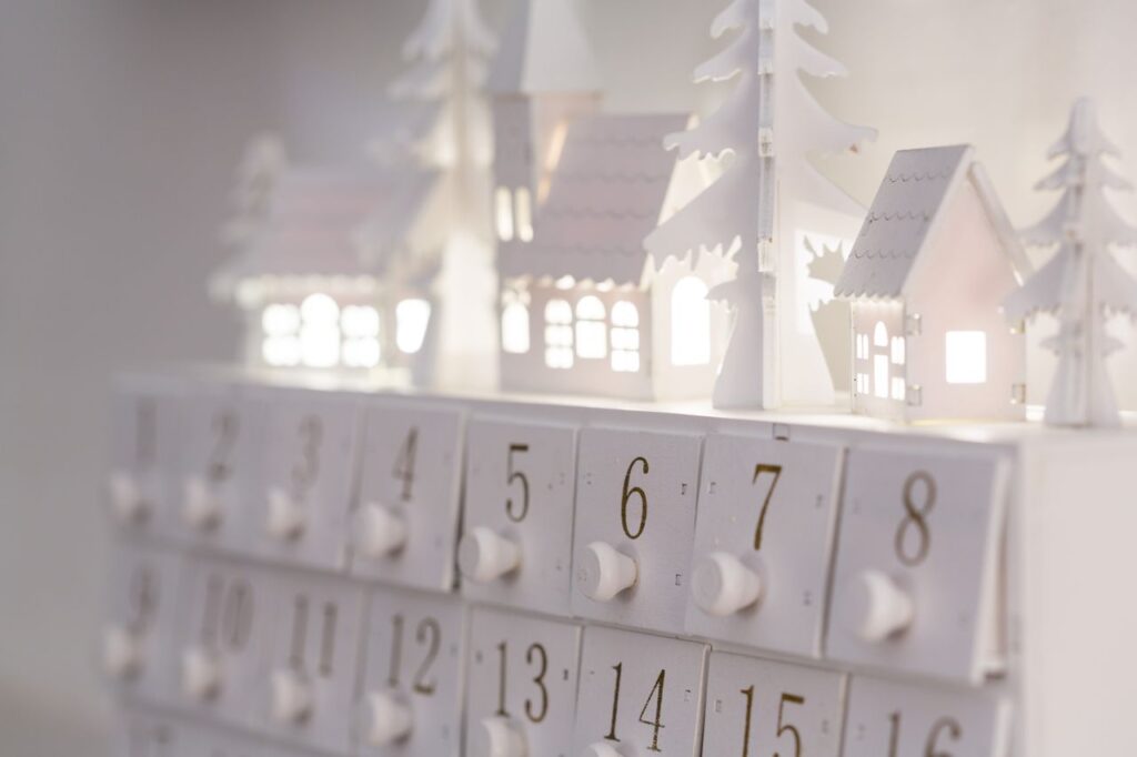pexels-photo-195030-195030 Beautiful minimalist advent calendar with illuminated houses and numbers for winter decor and festive ambiance.