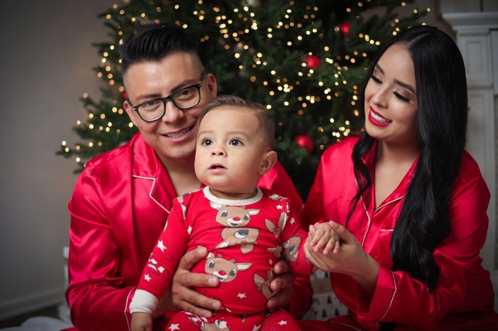 A cheerful family in red pajamas celebrates Christmas by the tree in Oklahoma City.