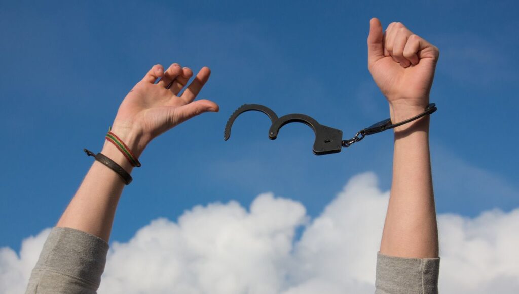 pexels-photo-247851-247851 Symbolic image of freedom with open handcuffs against a bright blue sky.