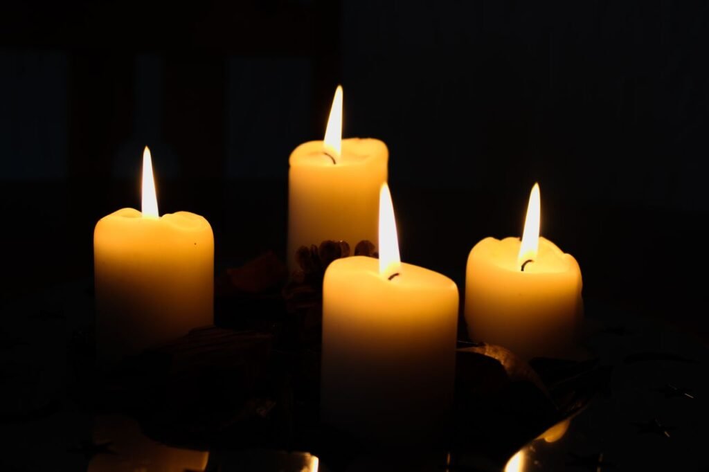 A serene image of a glowing four-candle advent wreath, perfect for holiday ambiance.