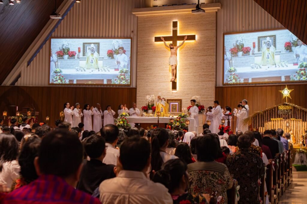 A vibrant Christmas mass with congregation, altar servers, and a priest in a church.