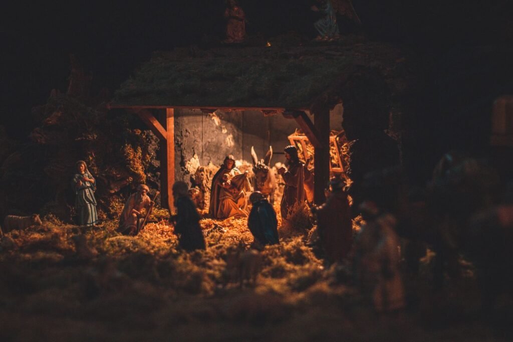 Small figurines placed in nativity scene and demonstrating story from Bible about Birth of Jesus Christ