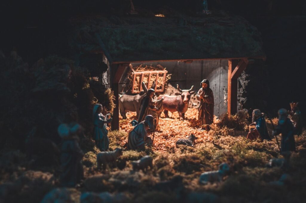 Nativity scene with tiny figurines of people and animals demonstrating biblical story of Birth of Jesus Christ