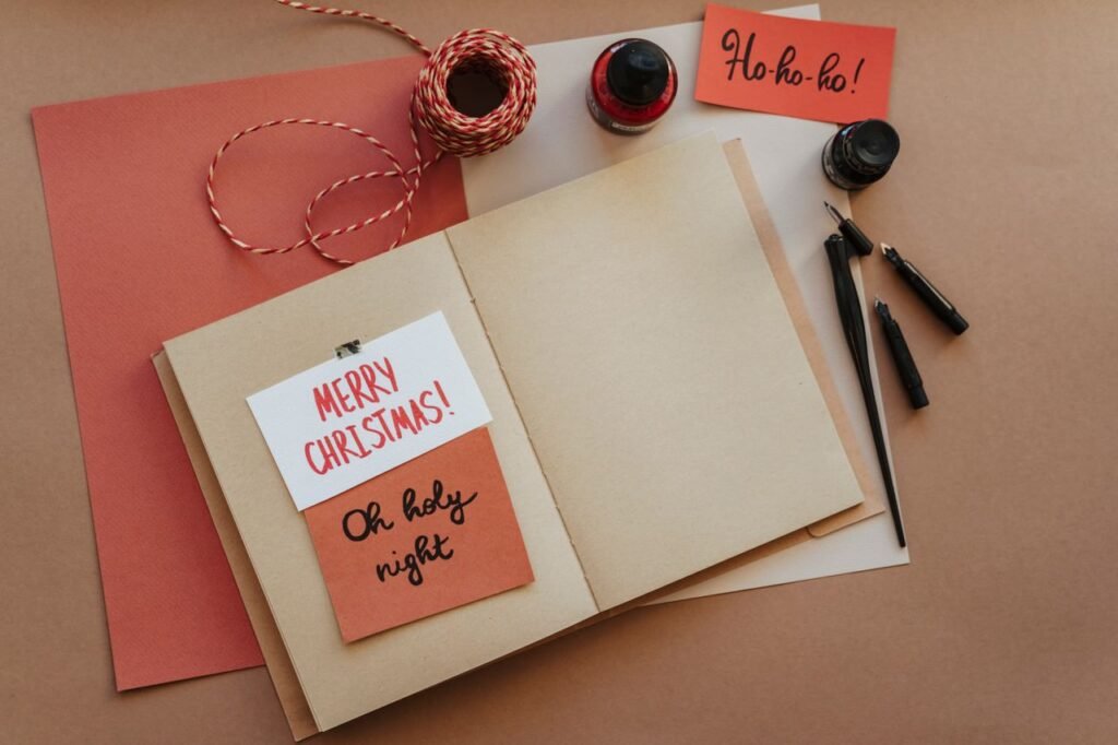 pexels-photo-6149048-6149048 A warm and cozy still life of Christmas card crafting materials on a brown background.