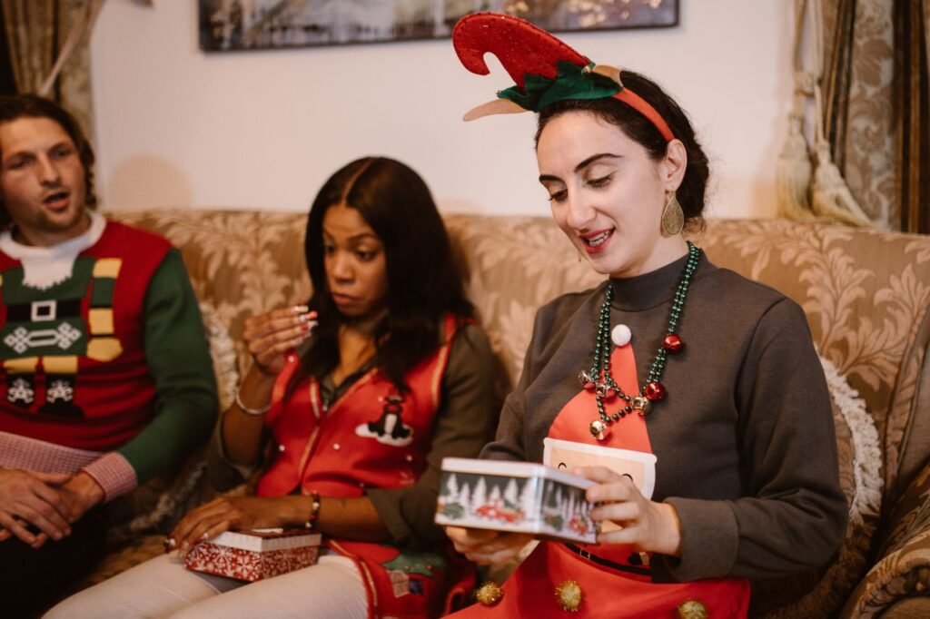 A joyful holiday gathering with friends exchanging gifts in festive attire.