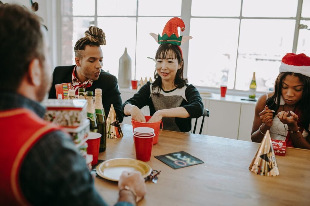 A diverse group of adults enjoying a festive Christmas celebration indoors.